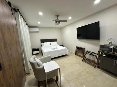 a bedroom with a bed and a flat screen tv at House 4-71 in Cartagena de Indias