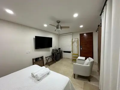 a bedroom with a bed and a chair and a television at House 4-71 in Cartagena de Indias
