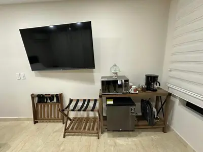 a living room with a table and a tv on the wall at House 4-71 in Cartagena de Indias