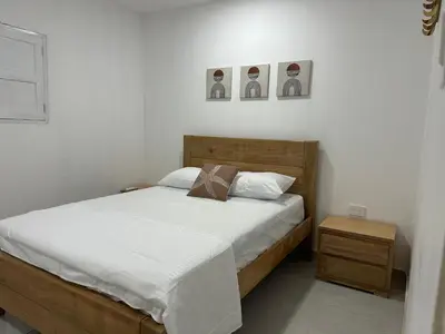 a bedroom with a bed and two pictures on the wall at Coral del Mar 1 in Tolú