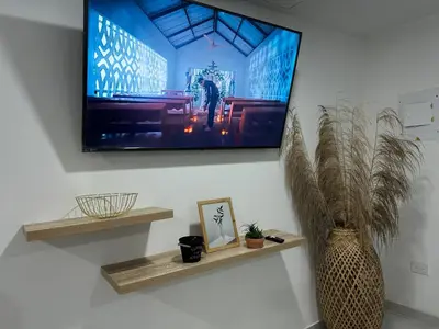 a flat screen tv hanging on a wall at Coral del Mar 1 in Tolú