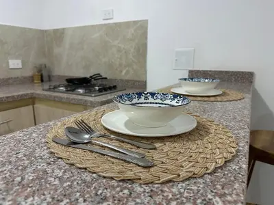 a kitchen counter with two bowls and utensils on it at Coral del Mar 1 in Tolú