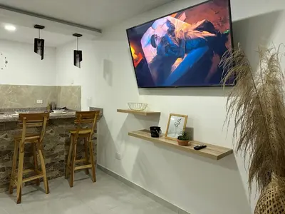 a living room with a large screen on the wall at Coral del Mar 1 in Tolú