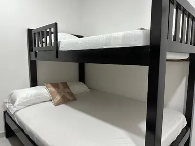 two bunk beds with white sheets and a pillow at Coral del Mar 1 in Tolú