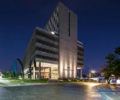 a tall building with a sign on it at night at Movich Buró 51 in Barranquilla