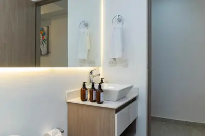 a bathroom with a sink and a mirror at Luxury Apartment Suite Lake View 2 min Airport in Cartagena de Indias