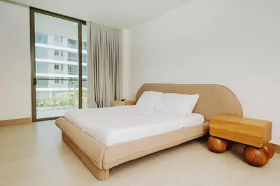 a bedroom with a bed and a table and a window at Morros EOS Manzanillo del mar in Cartagena de Indias