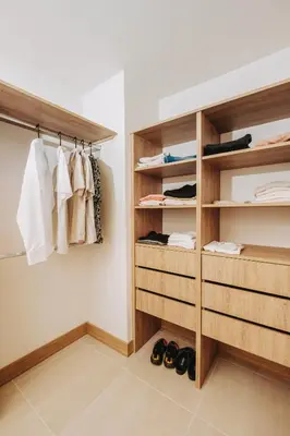 a walk in closet with wooden shelves and shoes at Morros EOS Manzanillo del mar in Cartagena de Indias