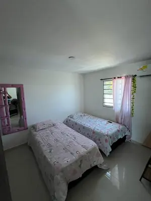 a bedroom with two beds and a mirror at Sebastián torres in Barranquilla