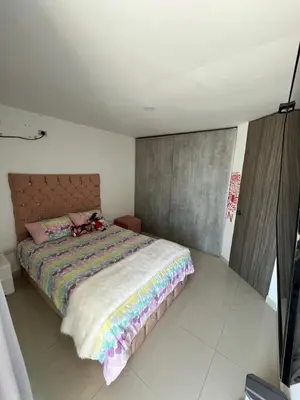 a bedroom with a bed with a stuffed animal on it at Sebastián torres in Barranquilla
