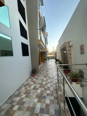 a hallway of a building with a checkered floor at Sebastián torres in Barranquilla