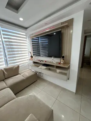 a living room with a couch and a flat screen tv at El encanto de Cartagena in Cartagena de Indias