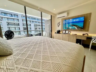 a bedroom with a large bed and a tv at Morros Zoe - Ocean View Paradise, Serena Del Mar, Cartagena in Cartagena de Indias