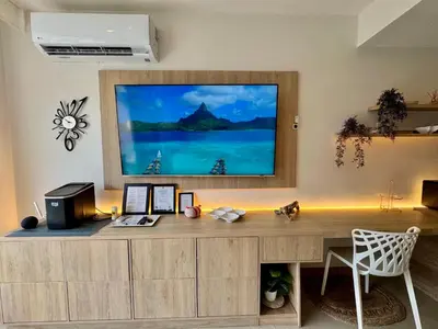 a desk with a large television on a wall at Morros Zoe - Ocean View Paradise, Serena Del Mar, Cartagena in Cartagena de Indias