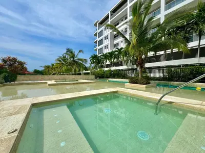 a swimming pool in front of a building at Morros Zoe - Ocean View Paradise, Serena Del Mar, Cartagena in Cartagena de Indias