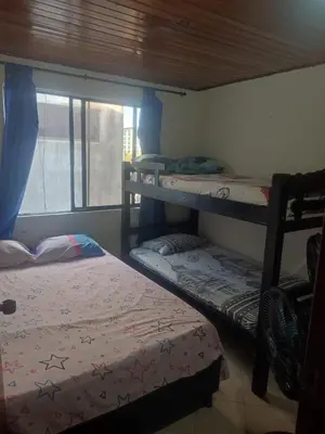 a bedroom with three bunk beds and a window at Sun Beach 41 in Cartagena de Indias
