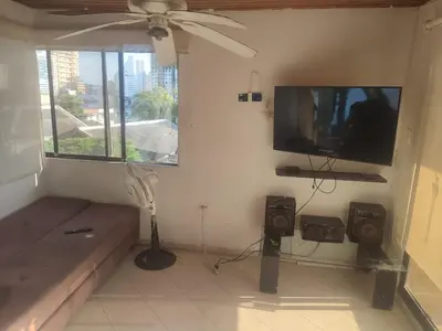 a living room with a couch and a flat screen tv at Sun Beach 41 in Cartagena de Indias