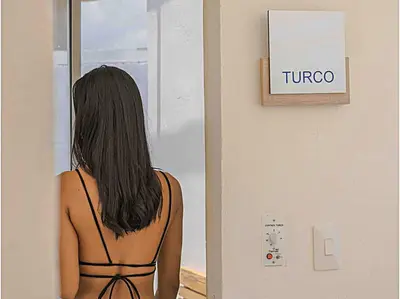 a woman in a black dress looking in a window at Tu refugio en la playa, moderno cómodo con estilo in Cartagena de Indias