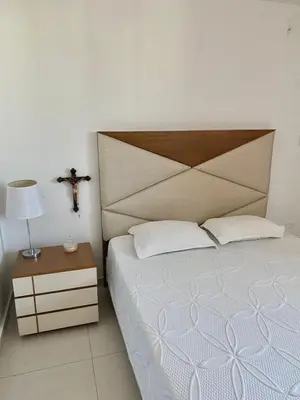 a bedroom with a bed with a cross on the wall at Apartamento en Riomar a pocas cuadras CC Buenavista in Barranquilla