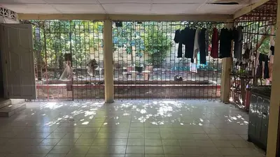 a room with a window with clothes on racks at Habitacion en casa zona carnaval in Barranquilla