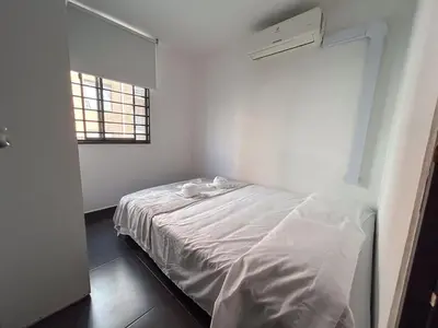 a bedroom with a white bed in a room with a window at Comodo apartamento en el norte de Barranquilla in Barranquilla