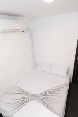a bed in a room with white sheets and pillows at Comodo apartamento en el norte de Barranquilla in Barranquilla