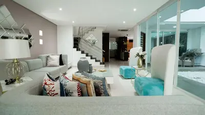 a living room with a couch and chairs and a staircase at MQ CROWN HOUSE CASTIllO in Cartagena de Indias