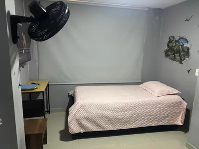 a bedroom with a bed and a hat on the wall at Gisela Wax More Hostel in Cartagena de Indias