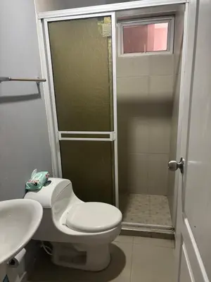 a bathroom with a shower and a toilet and a sink at Gisela Wax More Hostel in Cartagena de Indias