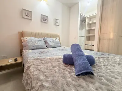 a bedroom with a large bed with blue towels on it at Hermoso apartamento en Manzanillo del Mar in Cartagena de Indias