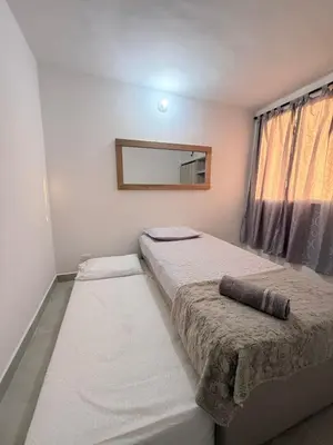 a bedroom with two beds and a mirror at Hermoso apartamento en Manzanillo del Mar in Cartagena de Indias