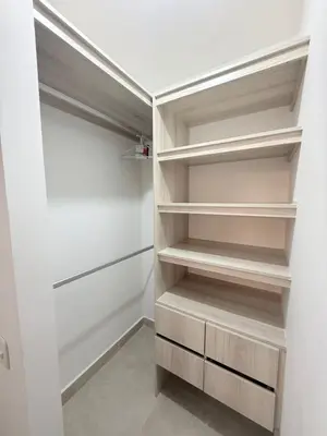 a walk in closet with white walls and wooden shelves at Hermoso apartamento en Manzanillo del Mar in Cartagena de Indias
