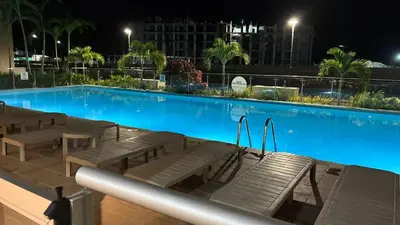 a large swimming pool with benches next to a building at Hermoso apartamento en Manzanillo del Mar in Cartagena de Indias