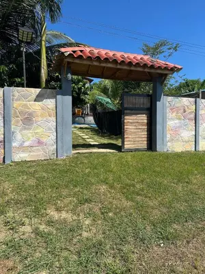 a gazebo with a red roof on a yard at La Dolce Villa! in El Mamey