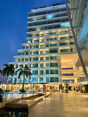 a large building with palm trees in front of it at Morros Seaway 935 Apto 806 in Cartagena de Indias