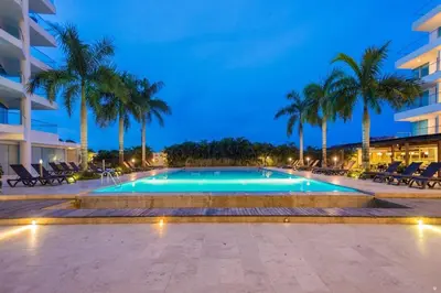 a swimming pool with palm trees and a building at Morros Seaway 935 Apto 806 in Cartagena de Indias