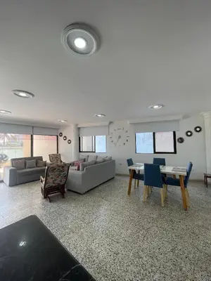 a living room with a couch and a table and chairs at Two Bedroom Apt in Cartagena de Indias