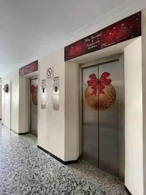 a row of elevators in a building with a cookie on the door at Two Bedroom Apt in Cartagena de Indias