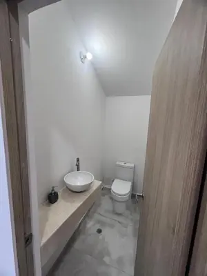 a bathroom with a white toilet and a sink at Villa Sabanilla Casa bifamiliar campestre con piscina privada Aire acondicionado Tranquilidad total in Puerto Colombia