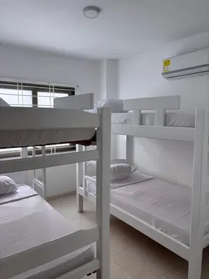 a dorm room with three bunk beds in it at Apartamento familiar en coveñas cerca del mar in Coveñas