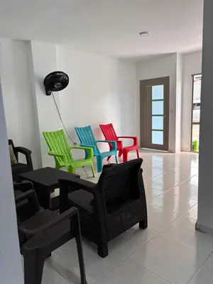a room with four colorful chairs and a table at Apartamento familiar en coveñas cerca del mar in Coveñas