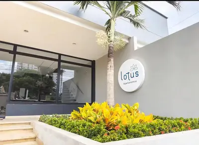 a building with a palm tree in front of it at New apartment 5 minutes from the beach in Cartagena de Indias