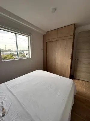 a bedroom with a large white bed and a window at New apartment 5 minutes from the beach in Cartagena de Indias