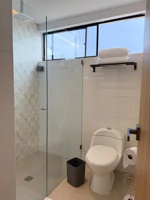 a bathroom with a toilet and a glass shower at NEW Unique 270º view above the city walls in Cartagena de Indias