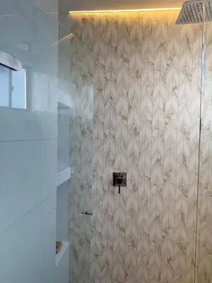 a bathroom with a shower with a tiled wall at NEW Unique 270º view above the city walls in Cartagena de Indias