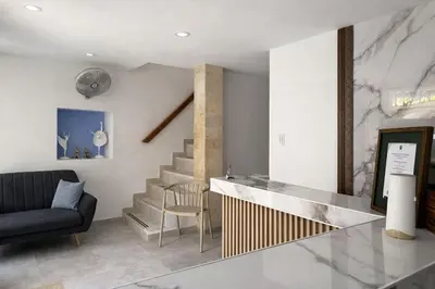 a living room with a staircase and a couch at Hotel Getsemaní Central in Cartagena de Indias