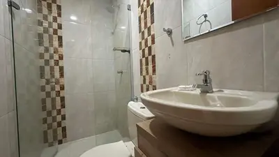 a bathroom with a sink and a toilet and a shower at Hotel Getsemaní Central in Cartagena de Indias
