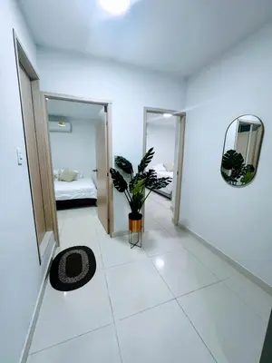 a white room with a bed and a potted plant at Comfortable in the heart of the city! in Estación El Salto