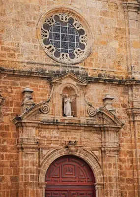 a brick building with a clock above a red door at Comfortable in the heart of the city! in Estación El Salto