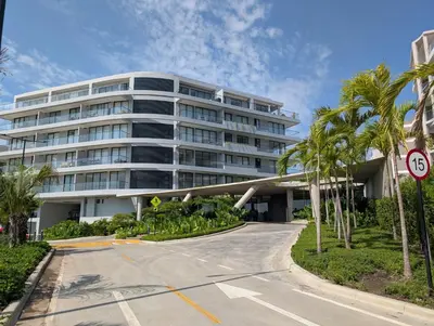 a large white building with palm trees in front of it at Manzanillo Morros Kai 526 in Cartagena de Indias